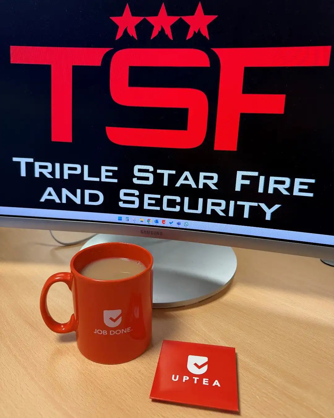 Triple Star Fire and Security on a Screen with an Uptick Coffee Mug