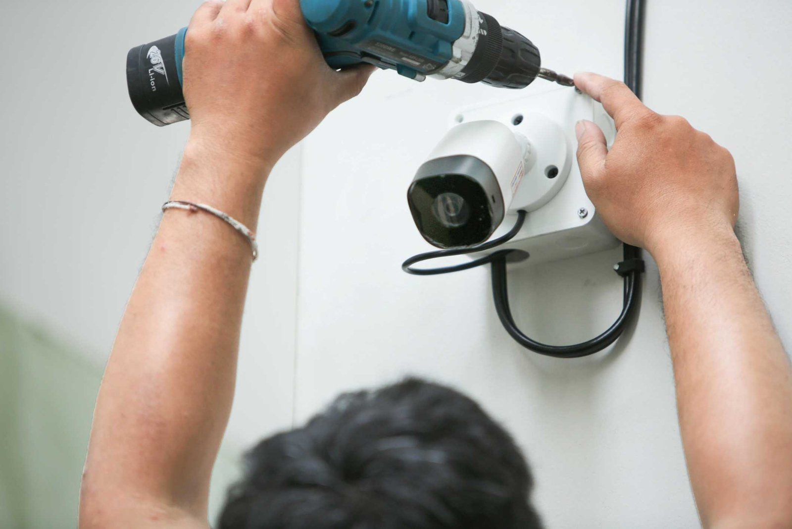 Technician installing CCTV camera